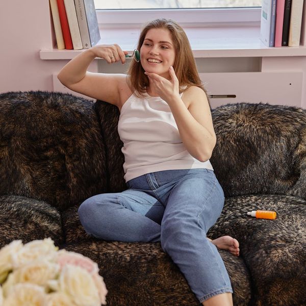 Person smiling and stretching in a bright, airy room.